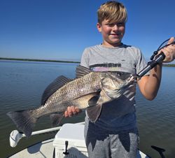 Angler with a big black drum fish catch at New Smyrna Beach