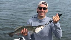 Photograph of a spotted weakfish caught by a person at New Smyrna Beach