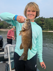 Big 65-inch Smallmouth Bass caught in Sturgeon Bay's partly cloudy waters!