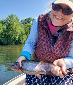 A group of 5 people fishing with rainbow trout in MO