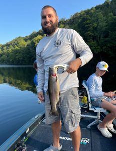 A fisherman holding a 14-inch rainbow trout in Kimberling City