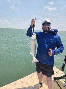 A fisherman with a catch of one fish at South Padre Island