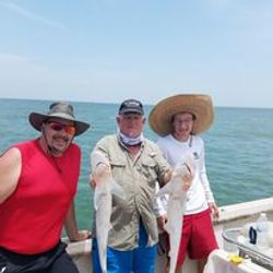 Three people enjoying fishing in Galveston
