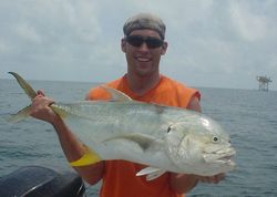 A fisherman catches a Crevalle Jack in Galveston