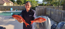2 fishing rods with fish caught in FL