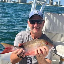 Angler with 17-inch fish in West Palm Beach, Florida, during cruises and fishing activities