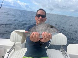 A lone angler reels in a 23-inch fish in the waters of West Palm Beach