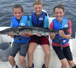Photograph of 3 people fishing on a boat in Florida