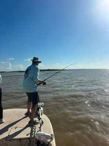 Fishing from boat with bent rod showing active catch in Matagorda TX waters