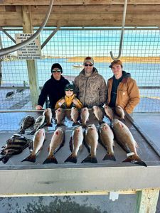 Successful fishing trip in Matagorda TX showing redfish, black drum, and sheepshead catch at cleaning station