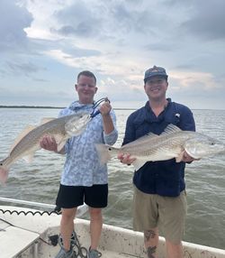 Two redfish caught fishing in Matagorda TX displayed on boat deck