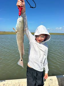 Angler holding redfish on fishing trip in Matagorda Texas