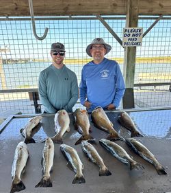 Fishing charter catch of speckled trout and redfish displayed on cleaning station in Matagorda TX