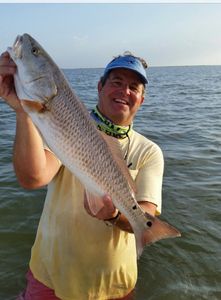 A fisherman holding a 22-inch fish in TX