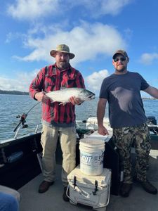 Angler holding a large lake trout caught while fishing at Myrtle Creek