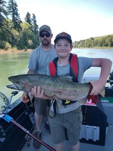Angler holding a large rainbow trout in Oregon