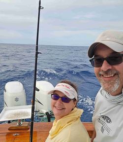 Two people on a boat in Florida enjoying cruises and fishing