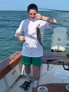 Reeling in a great catch on a peaceful day by the water.