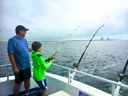 Two people enjoying a fishing cruise in Orange Beach
