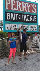A fisherman holding a large king mackerel while fishing in Murrells Inlet