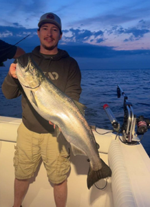 A single fisherman holds a 27-inch catch in MI