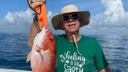 One person standing in Port Isabel fishing