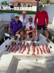 Two fishermen with a catch of 2 fish in Port Isabel