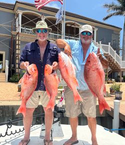 Four red snapper caught during fishing trip in Port Isabel TX displayed on boat dock