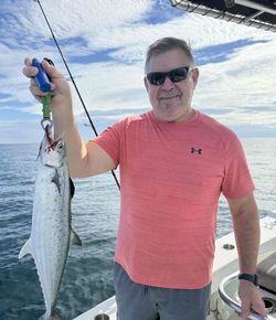 A fisherman catching a Spanish mackerel in FL