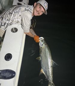 A person fishing for a tarpon in FL