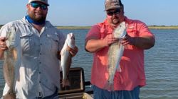 Two people fishing in Rockport with 3 fish