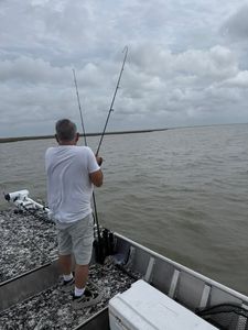 Fishing from boat deck with rods over water in Rockport TX