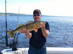 An angler holding a large pike-perch fish