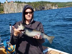A lone angler's successful catch at a remote fishing spot