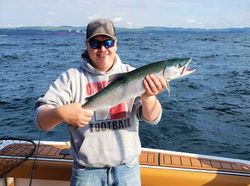 A person holding a 17-inch pink salmon in a location with the zip code 60096.