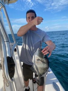 A person fishing for a black drum in FL