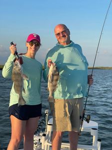 Two anglers holding black drum fish in Corpus Christi