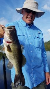 A fisherman holding a large Florida Bass fish in South Bay