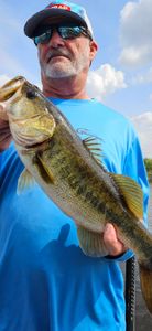 Angler holding freshly caught bass fish in South Bay FL