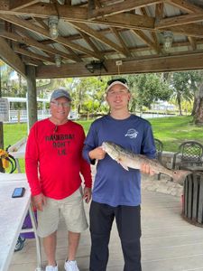 A couple fishing in Florida, with a big 21-inch catch