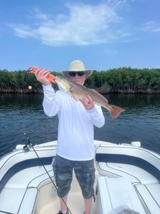 A fisherman holds a 19-inch redfish caught in Crystal River