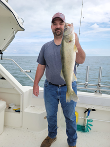 A person fishing at Port Clinton with a 27-inch fish