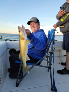 A lone fisherman casting his line in the waters of Port Clinton