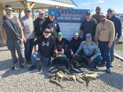 Fishing group displaying their catch of walleye and perch at Port Clinton OH marina