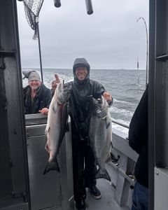 Two anglers with chum salmon and rainbow trout in CA