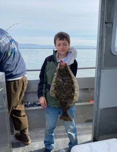 Fisherman with a large California Flounder in Richmond