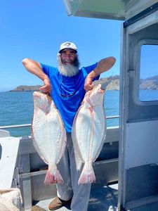 Angler with two big fish in California