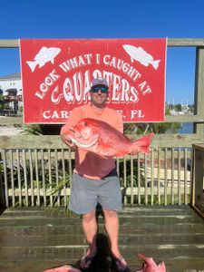 Angler landing a large fish at Carrabelle