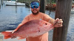 Photograph of one fisherman catching a 30-inch fish in Carrabelle