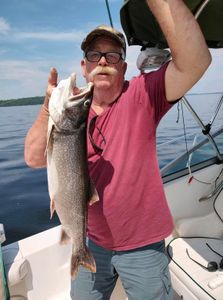 Fisherman catching a lake trout in VT